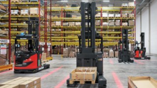 Die R-MATIC von Linde MH warten vor dem Regal auf den nächsten Fahrauftrag