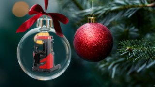 Weihnachtskugel mit Linde Schubmaststapler hängt am Tannenzweig