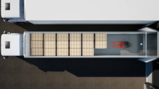 Vogelperspektive auf das automatische Beladen eines Lkw-Anhängers durch den Linde T-MATIC core.